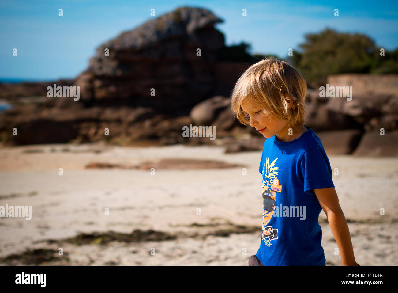 Young boy playing at the beach. Stock Photo
