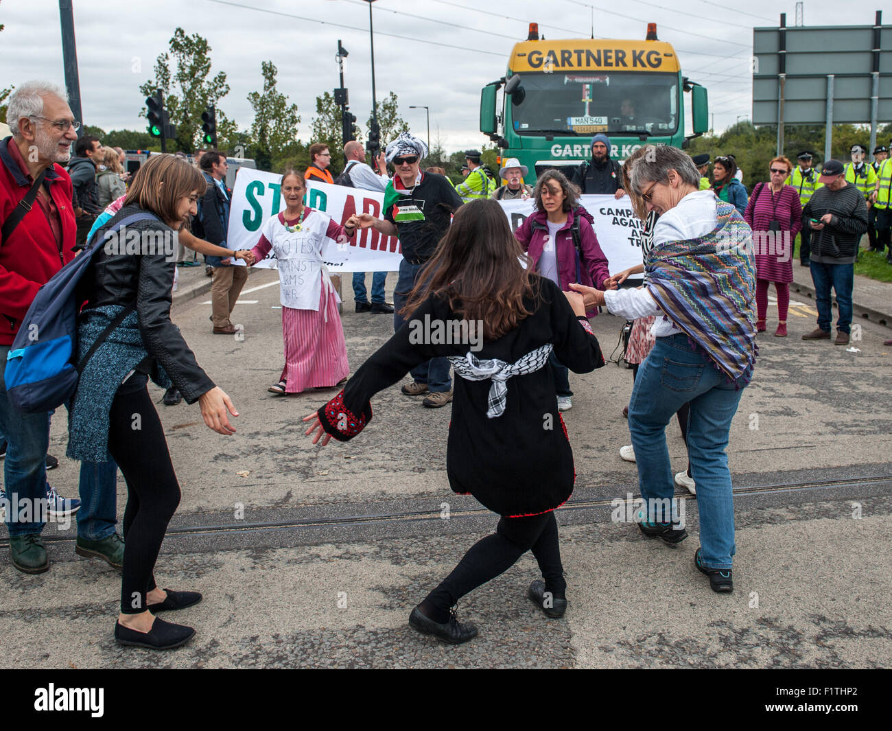 London, UK. 7th September, 2015. Activists block the delivery of a military vehicle during a protest against the DSEI, one of the world’s largest arms fairs. Activists are angered by the impact they claim the fair has on the “arms trade and repression.” The protesters aim to hold a week of action against the fair to disrupt the smooth running of the event which is scheduled to take place from the 15th to the 18th of September 2015 at the ExCel Centre, Royal Victoria Dock. Credit:  Pete Maclaine/Alamy Live News Stock Photo