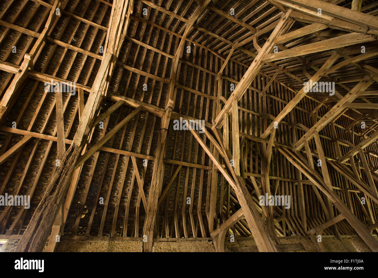 UK, Oxfordshire, Faringdon, Great Coxwell, 14th century Tithe Barn, interior roof stucture Stock Photo