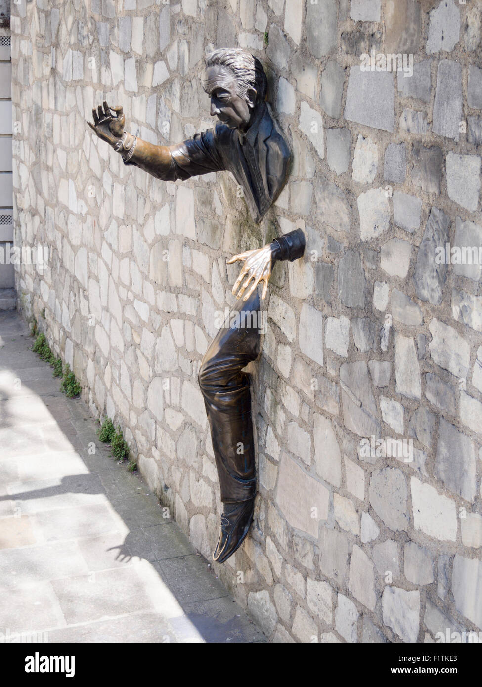 Walker Through Walls:  Le Passe-Muraille. Sculpture of a man walking through a stone wall in Montmartre Stock Photo