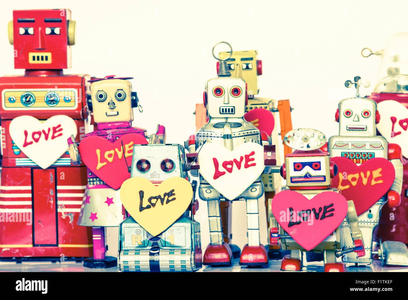 a line of retro robots in love Stock Photo - Alamy