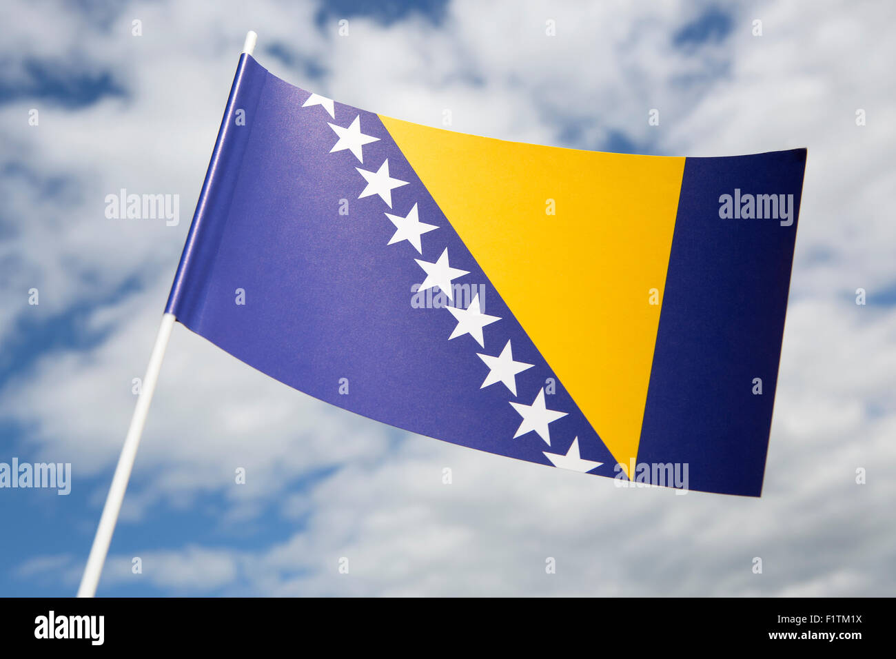 Bosnia Herzegovina flag in front of a blue sky Stock Photo