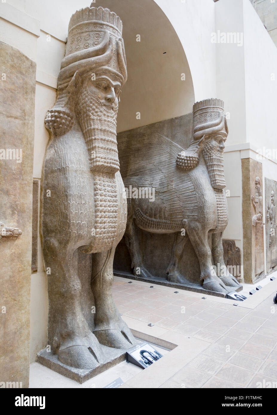 Winged human-headed Bulls guard the arch. Originally part of  Sargon II's capital Dur Sharrukin, now Khorsabad. Stock Photo