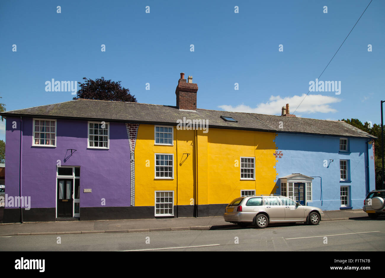 A row of houses in Bishop's Castle Shropshire painted bright funky colours. Stock Photo