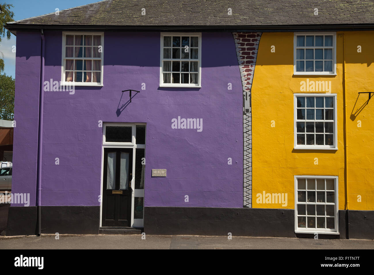A row of houses in Bishop's Castle Shropshire painted bright funky colours. Stock Photo