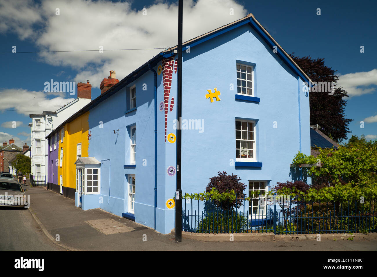 A row of houses in Bishop's Castle Shropshire painted bright funky colours. Stock Photo