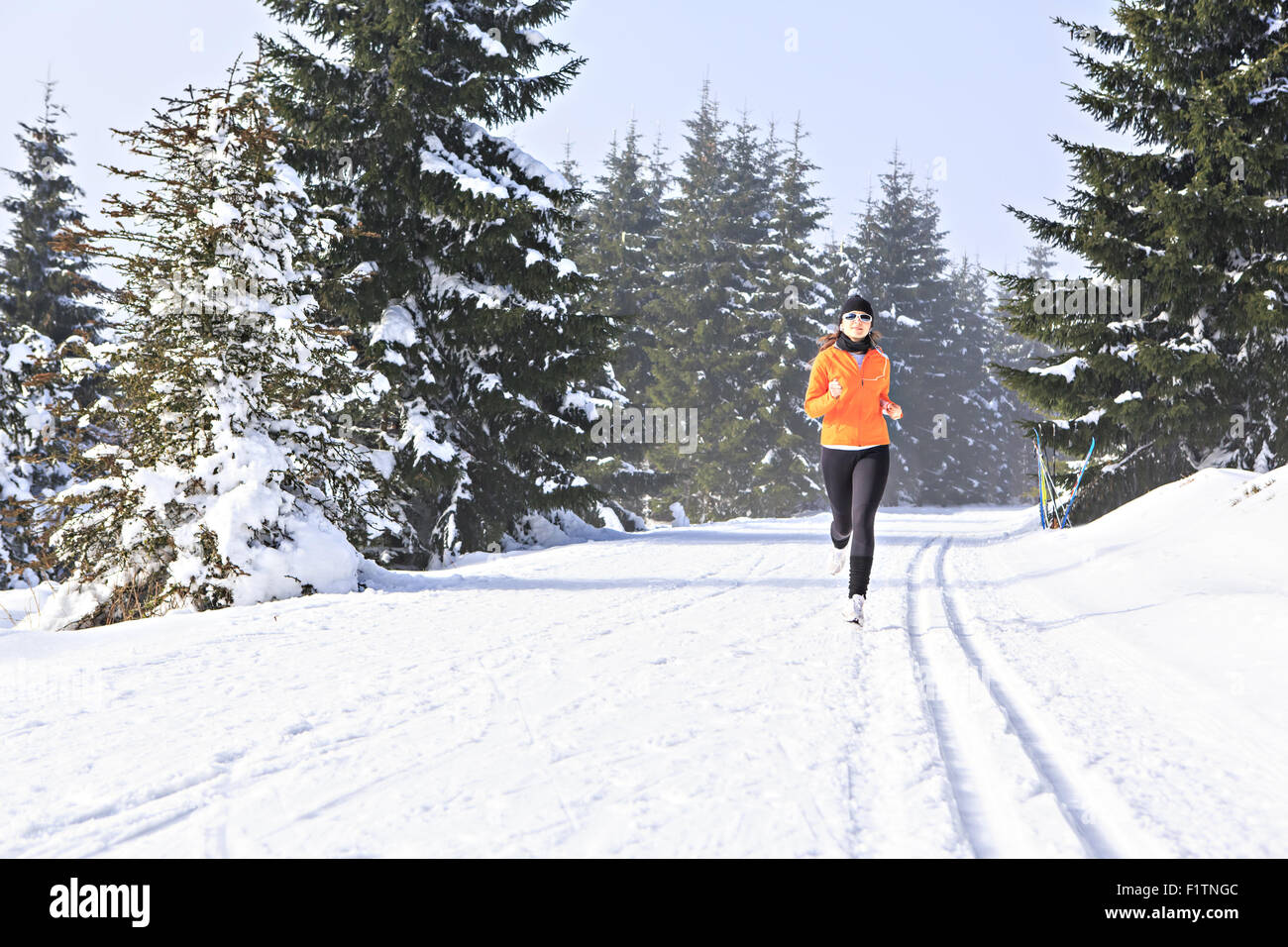 A young woman jogging in the wintry forest Stock Photo - Alamy