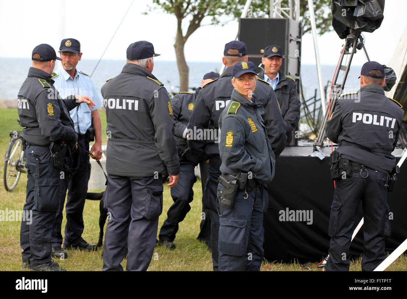 A female police officer standing out in group of several male police officers. Denmark. Stock Photo