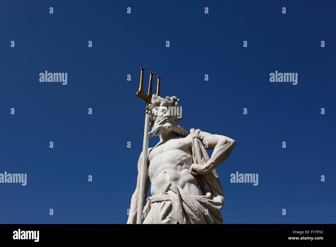 A statue in the garden of the Schloss Nymphenburg, portraying Neptune. Stock Photo