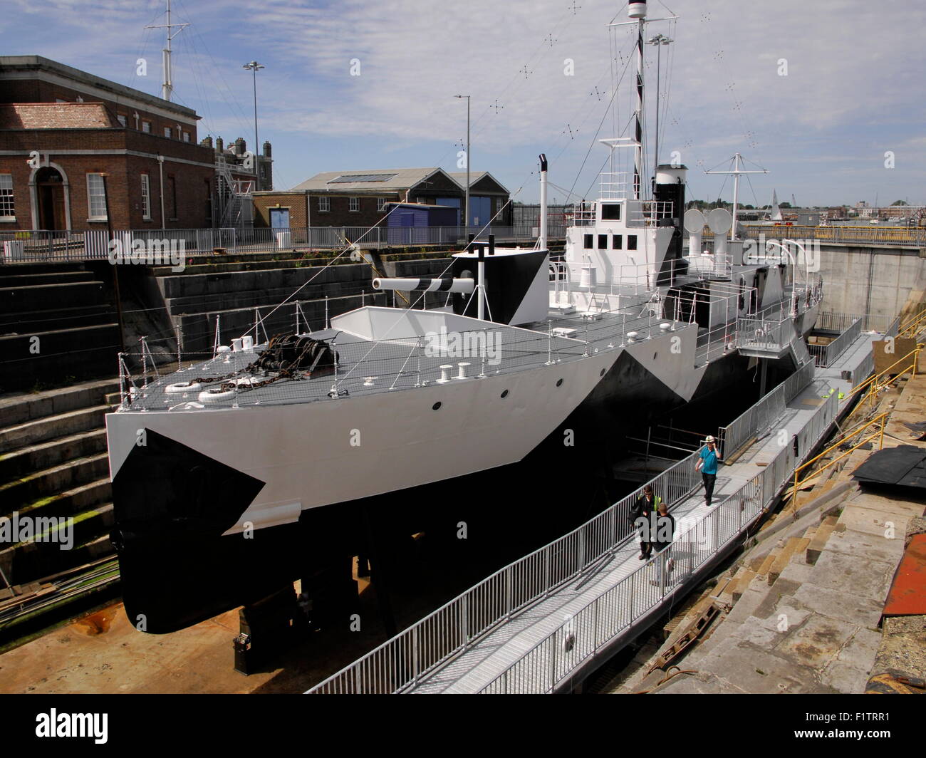 AJAXNETPHOTO. 4TH JUNE, 2015. PORTSMOUTH, ENGLAND. M-33 RESTORED - THE MONITOR CLASS SHIP HMS M-33 IN NR 1 DRY DOCK RESPLENDENT IN NEW DAZZLE PAINT OPENS TO THE PUBLIC MID SUMMER. PHOTO:JONATHAN EASTLAND/AJAX REF:D150406 5164 Stock Photo