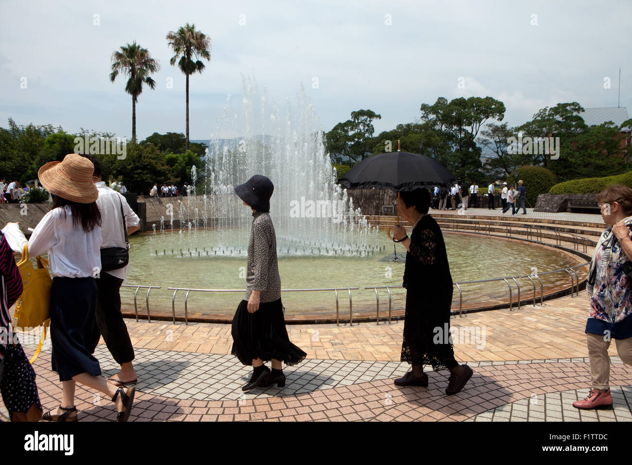 People at the 70th Anniversary of the atomic bombing of Nagasaki in 1945 walk by the Fountain of Peace in Peace Park, Japan Stock Photo