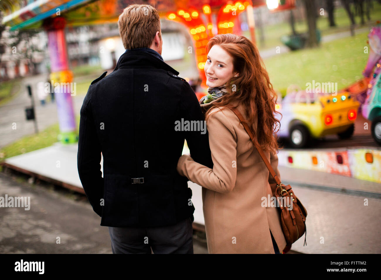 Young couple in the amusement park Stock Photo - Alamy