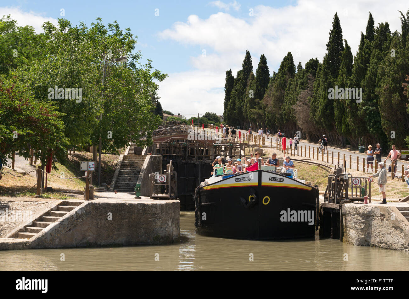 The large houseboat San  Antonius leaving the Fonserannes locks at Béziers, Languedoc-Roussillon, France, Europe Stock Photo