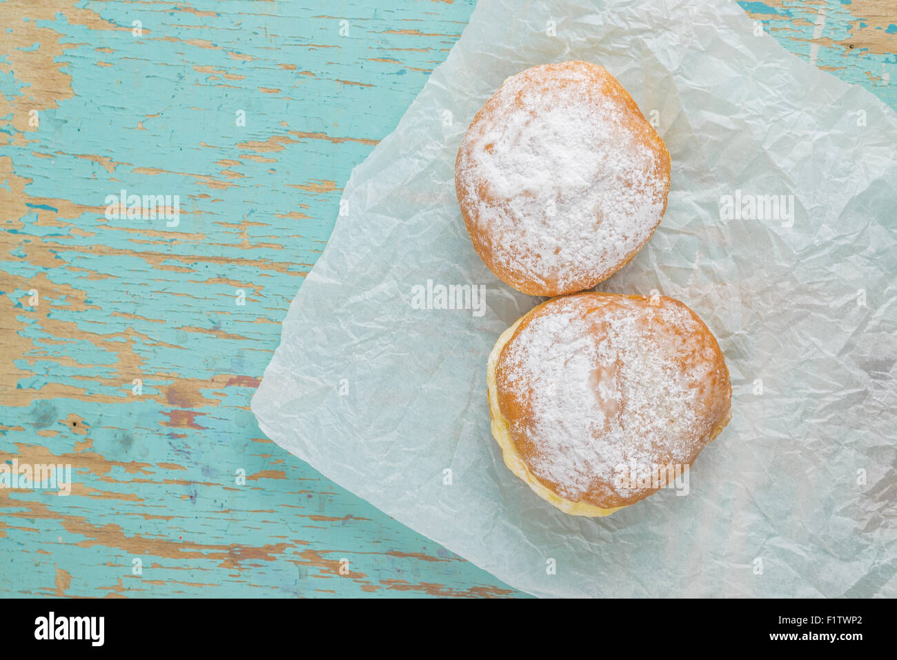 Sweet sugary donuts on rustic wooden kitchen table, top view of tasty ...