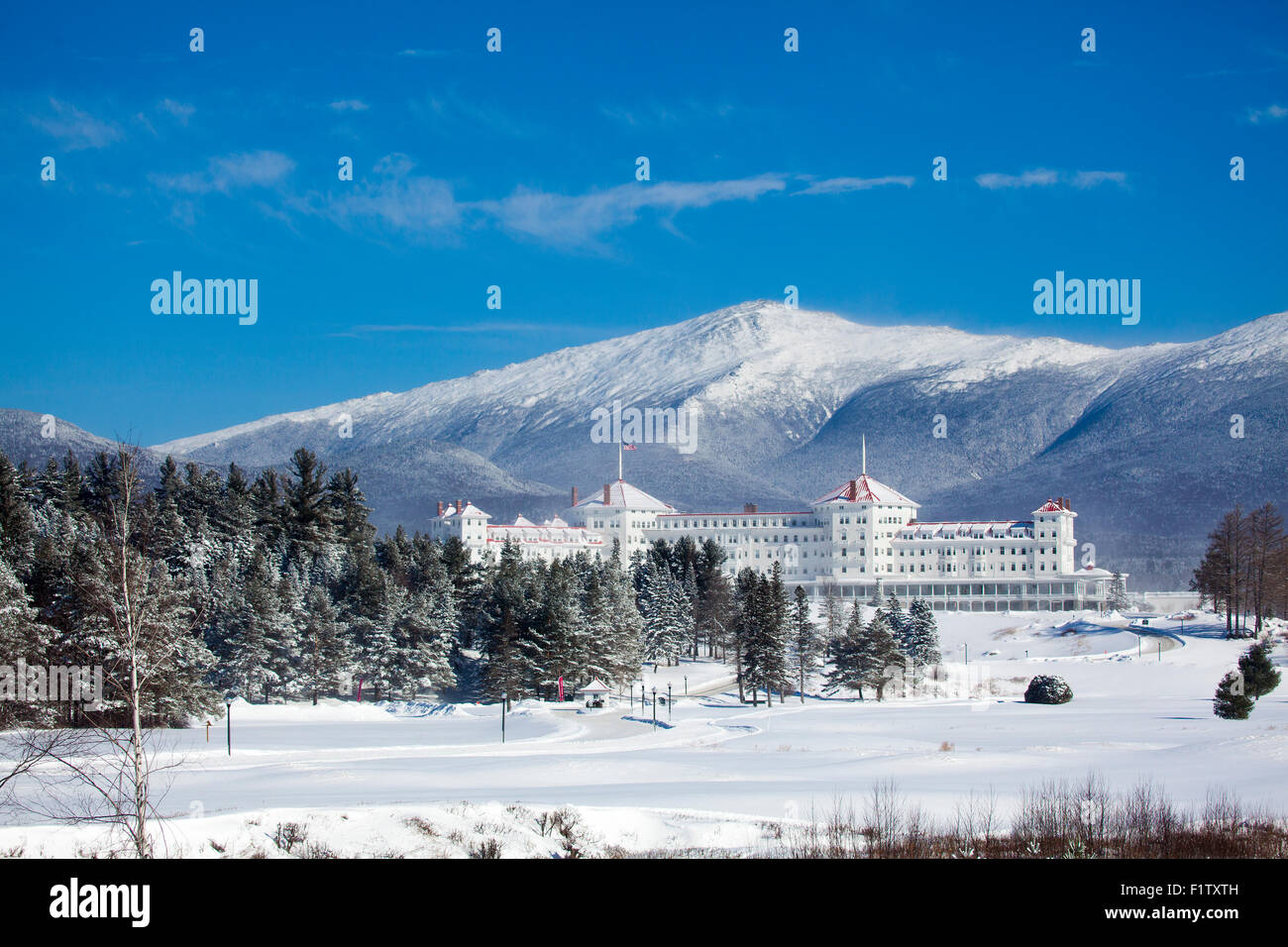 Facade of the majestic Mount Washington Hotel in winter with the White Mountains in the background. Bretton Woods, NH, USA. Stock Photo