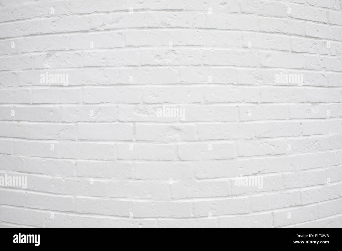 White painted brick wall with rounded curved in the center. Background use. Stock Photo