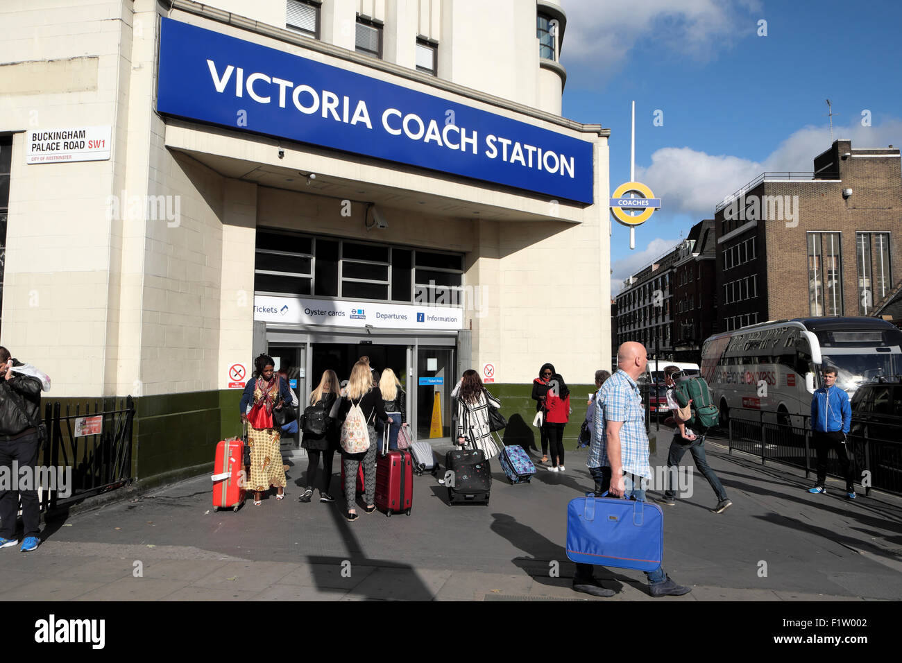 Travellers with luggage outside Victoria Coach Station building entrance and sign in London England UK   KATHY DEWITT Stock Photo