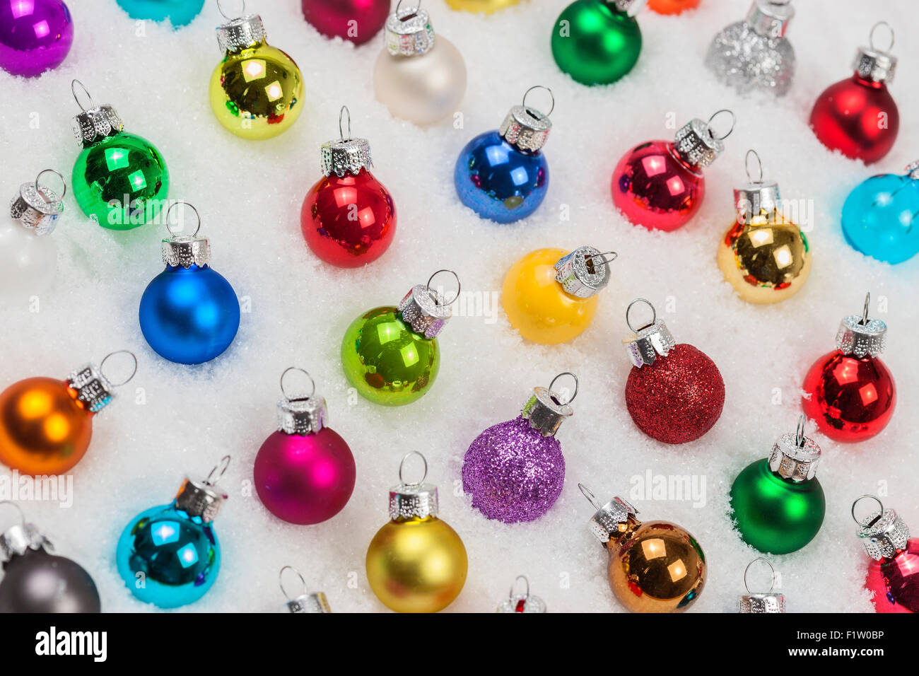 colourful christmas baubles in snow Stock Photo