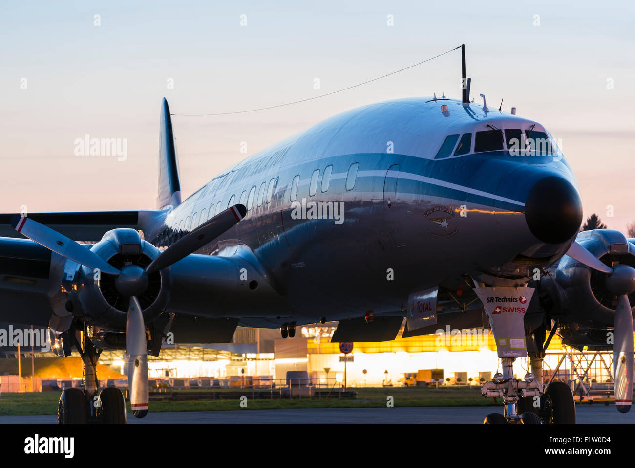 Classic vintage aircraft Lockheed L-1049 Super Constellation "HB-RSC" in the evening twilight at Zurich Kloten airport.