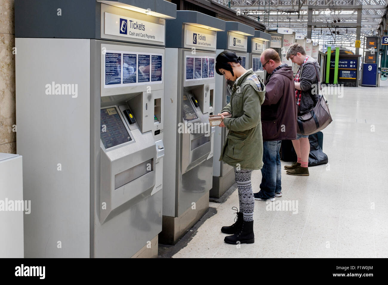 Passengers buying rail tickets at an automatic ticket machine on the platform, Glasgow Central Railway Station, Glasgow Scotland Stock Photo