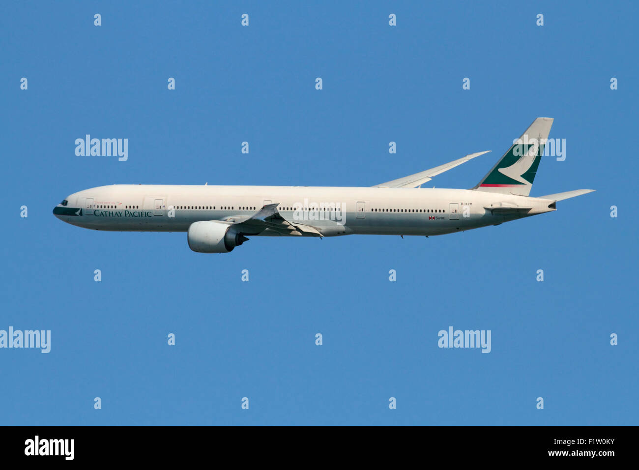 Air travel. Cathay Pacific Boeing 777-300ER long-haul widebody passenger jet plane in flight Stock Photo