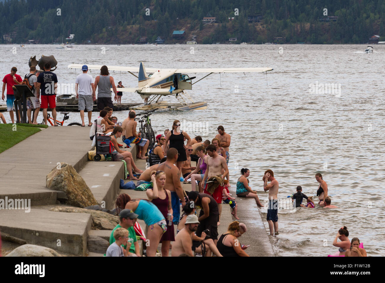 Coeur d' Alene, Idaho - August 01 : Amphibious plane floating on the lake with a crowd of people enjoying a summer day, August 0 Stock Photo