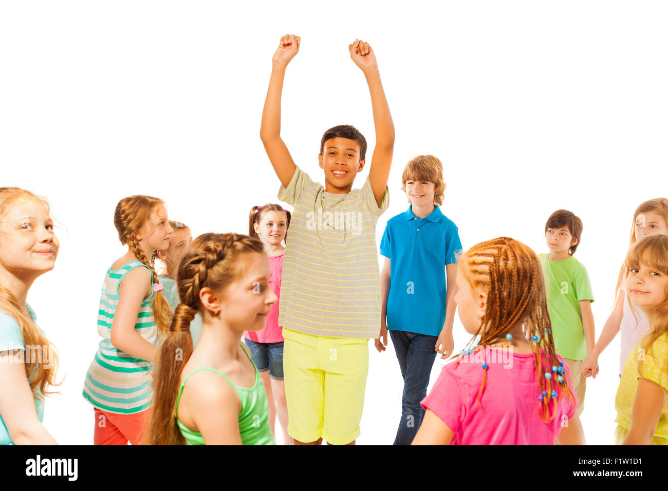 Boy stand in the crowd with lifted hands Stock Photo