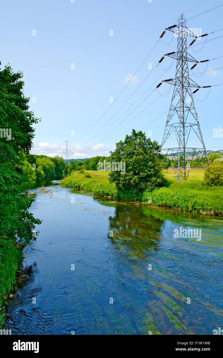 Electricity pylon in countryside by River Aire, England Stock Photo