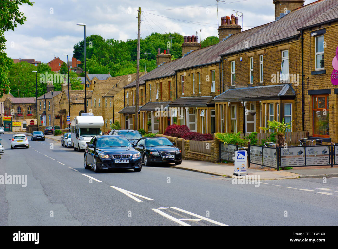 Traditional stone built houses and main street in Rodley, Leeds, West Yorkshire Stock Photo