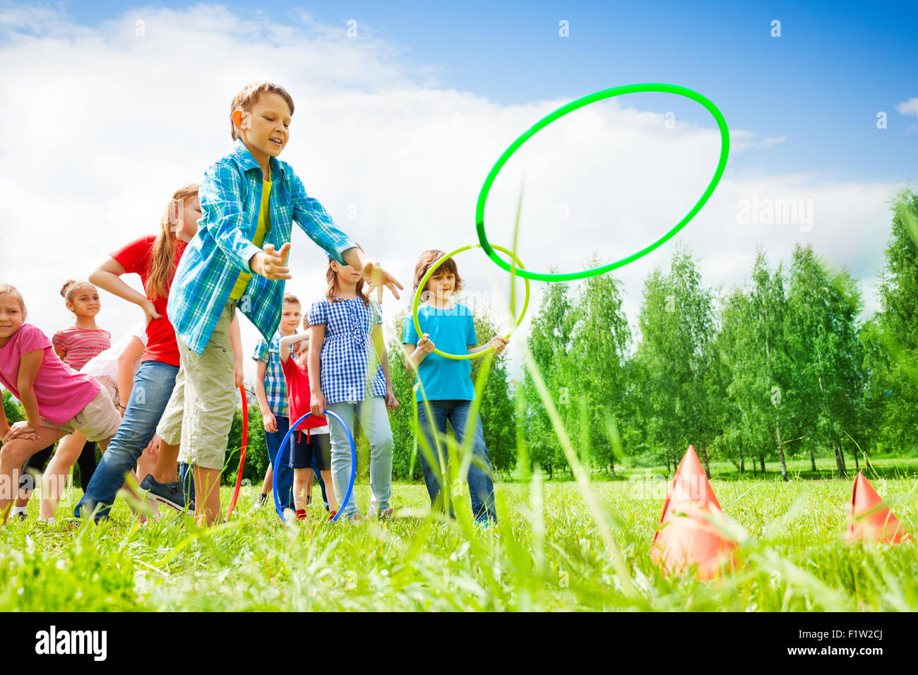Children playing and throwing colorful hoops Stock Photo Alamy