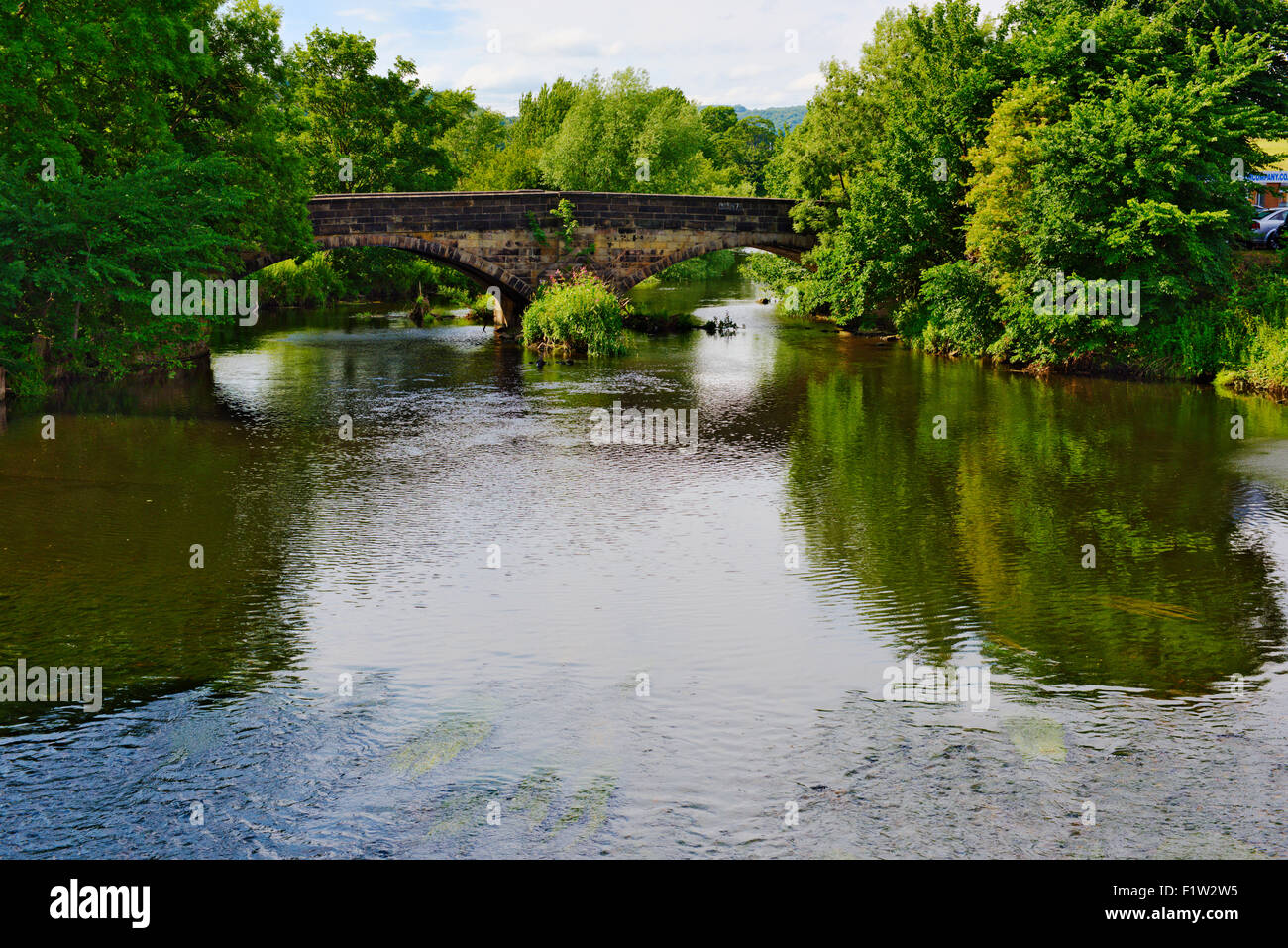 Old stone double arch bridge over river Aire, Apperley Bridge, Bradford