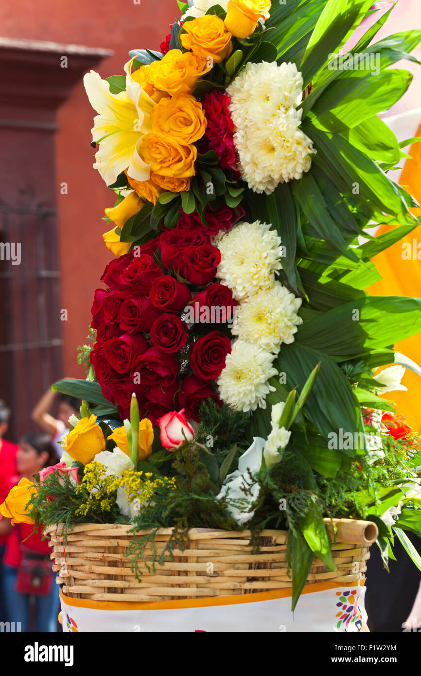 A FLOWER ARRANGEMENT is carried in a parade during the July GUELAGUETZA FESTIVAL  - OAXACA, MEXICO Stock Photo