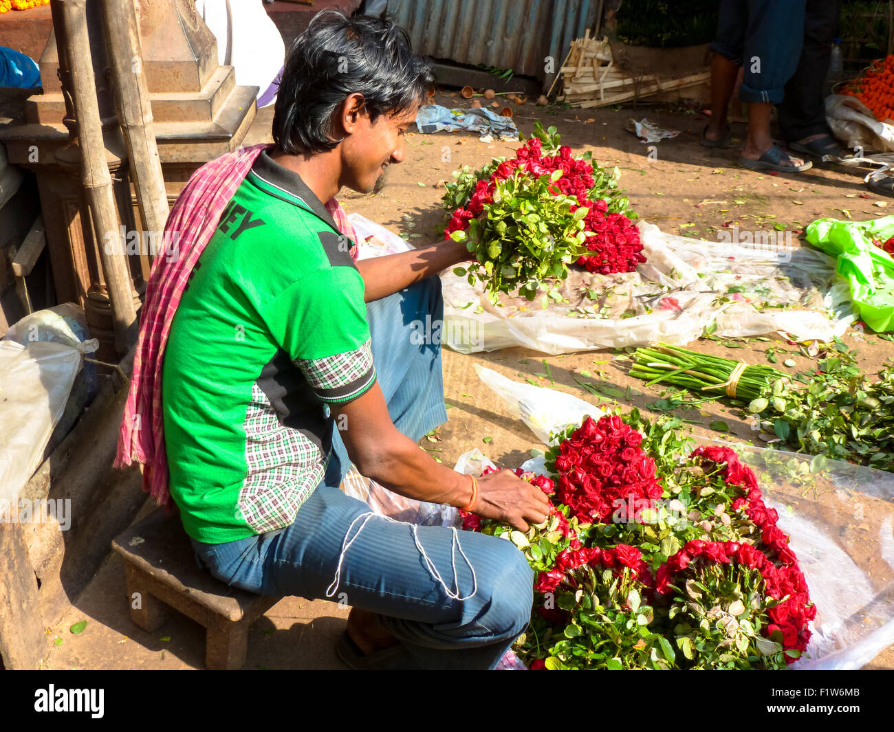 streetvendor with flowers at flowermarket in kolkata india Stock Photo