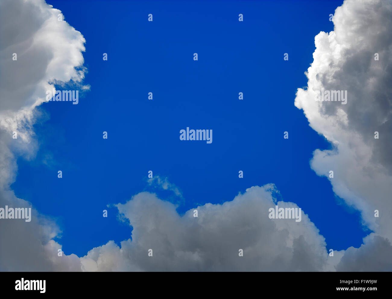 Gloomy Cumulus Clouds Formation on Blue Sky Stock Photo