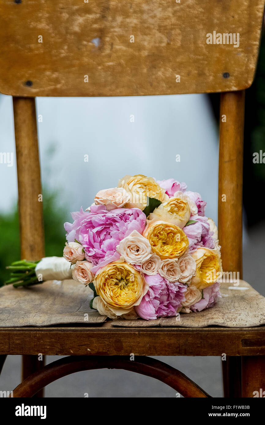 Beautiful wedding bouquet on a wooden shabby chair. Stock Photo