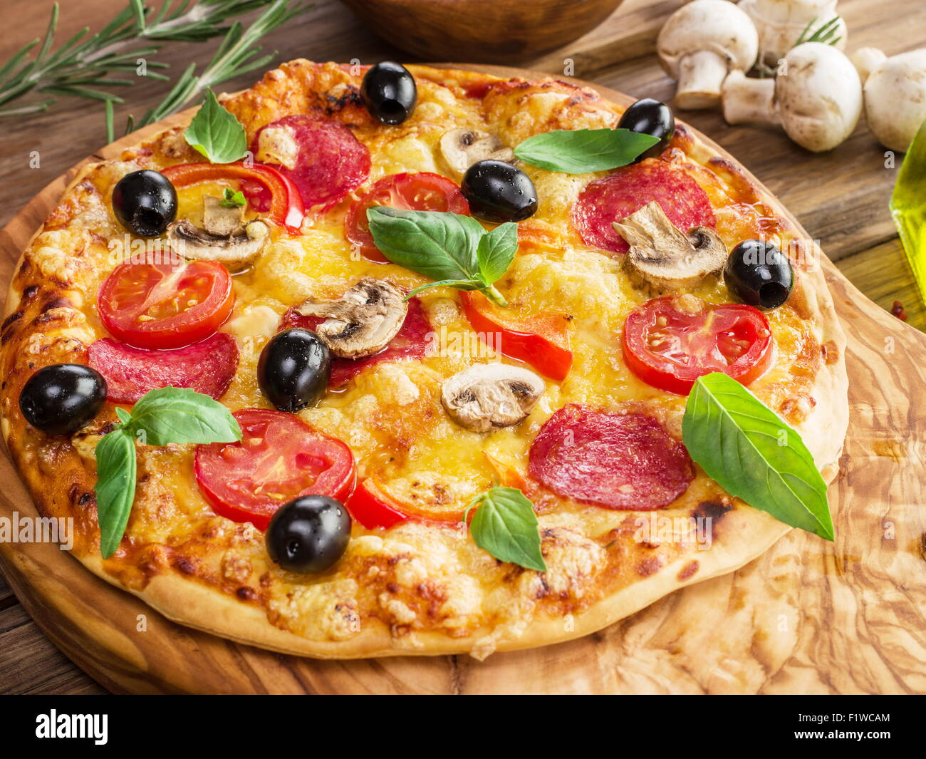 Pizza with mushrooms, salami and tomatoes. Top view. Stock Photo