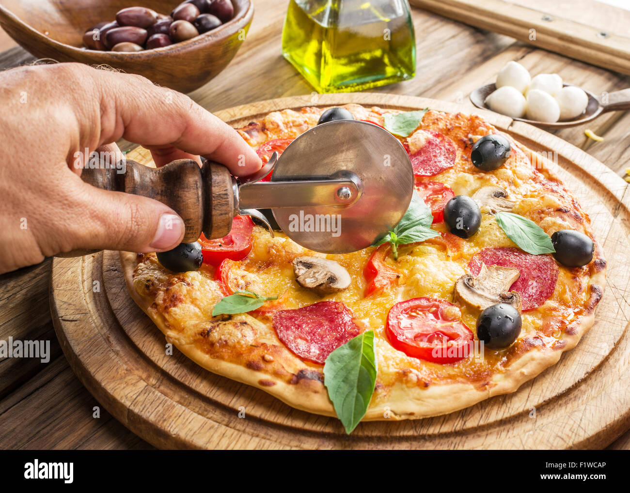 Pizza with mushrooms, salami and tomatoes. Top view. Stock Photo