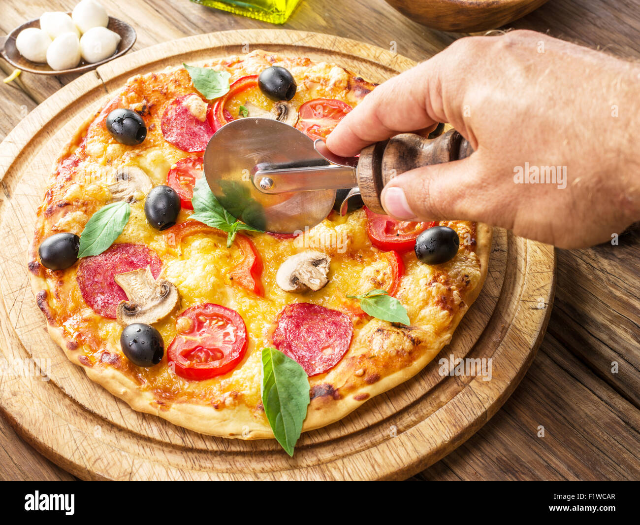 Pizza with mushrooms, salami and tomatoes. Top view. Stock Photo