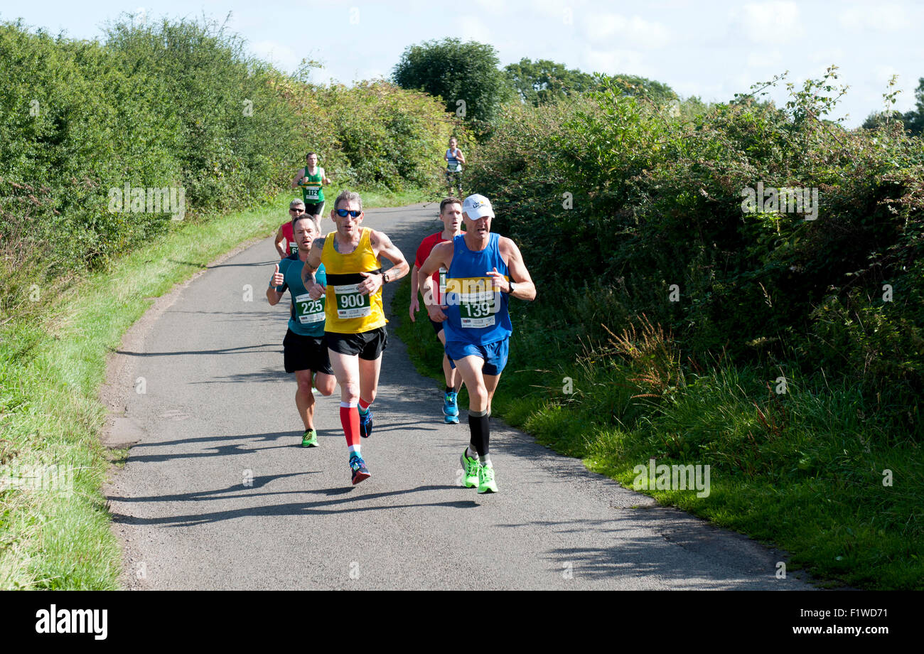 Half marathon runners on a country road, Warwickshire, UK Stock Photo