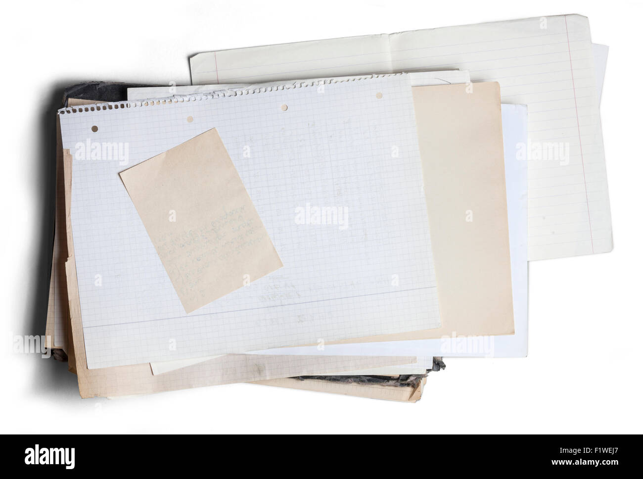 Sheet of yellowed and square graph paper on pile of aged papers Stock Photo