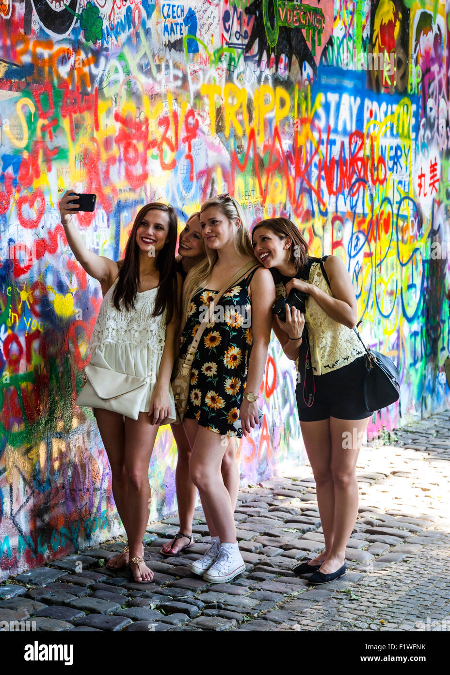 Group of Girls posing for a selfie by the John Lennon Wall, Prague, Czech Republic. Stock Photo