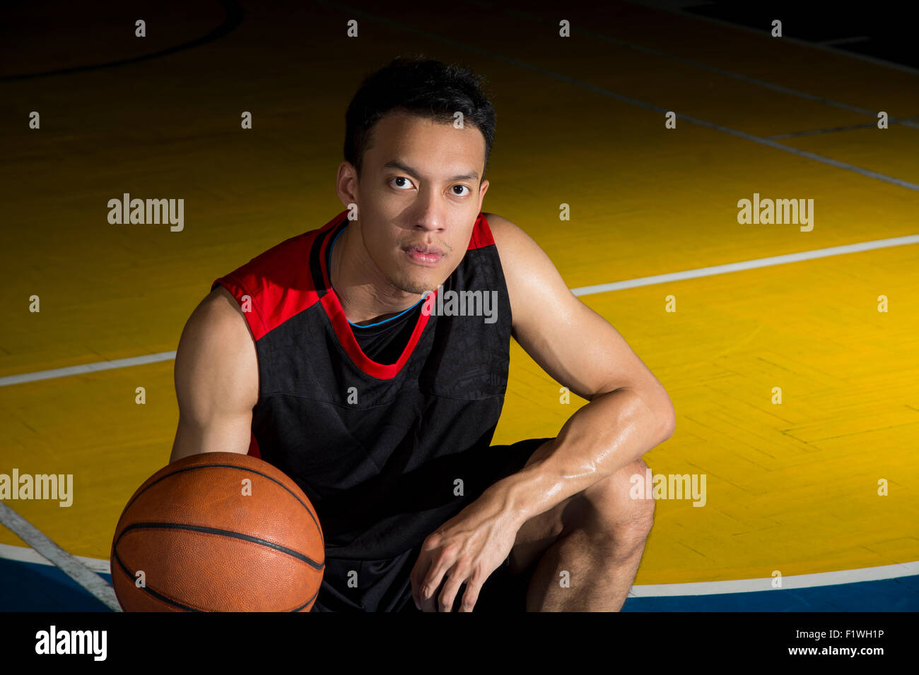 Asian young basketball player on basketball court Stock Photo