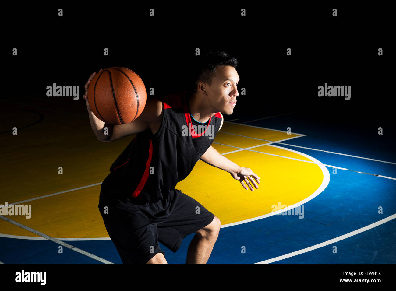 Asian young basketball player on basketball court Stock Photo