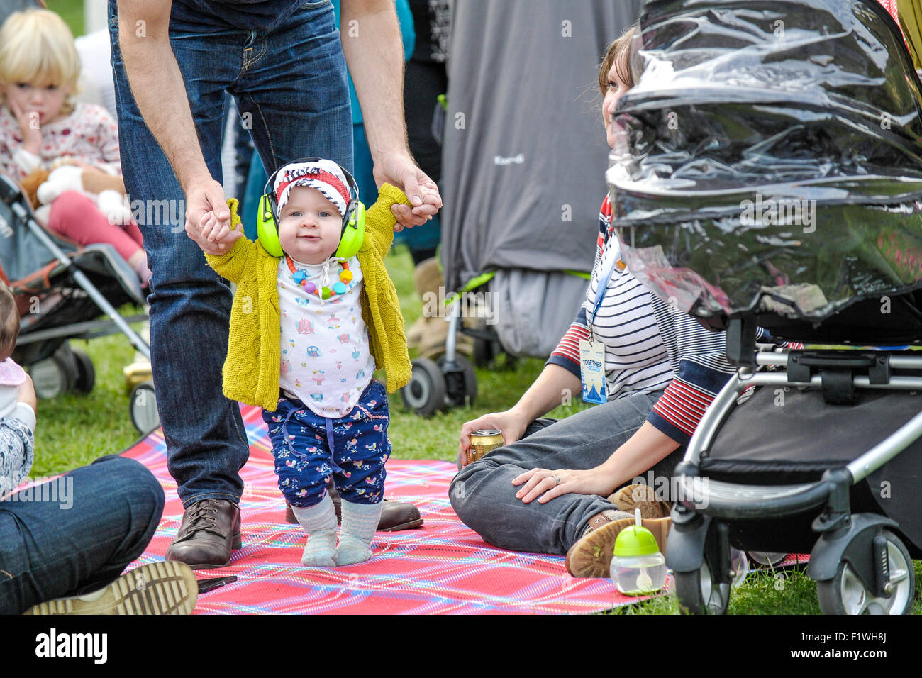 A toddler wearing ear defenders at Together The People Festival in Brighton. Stock Photo