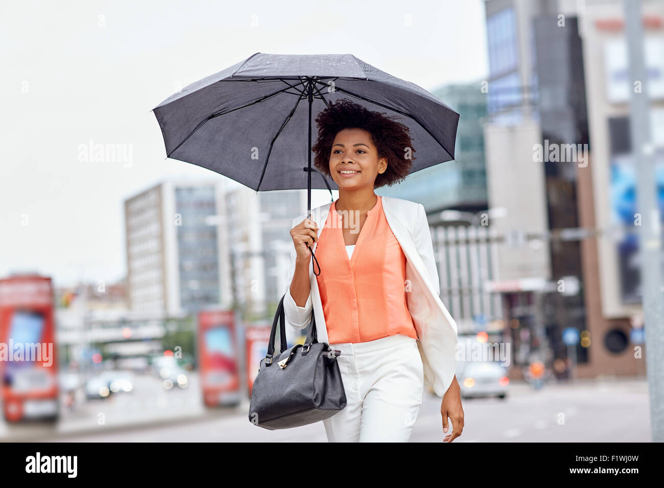happy african american businesswoman with umbrella Stock Photo - Alamy