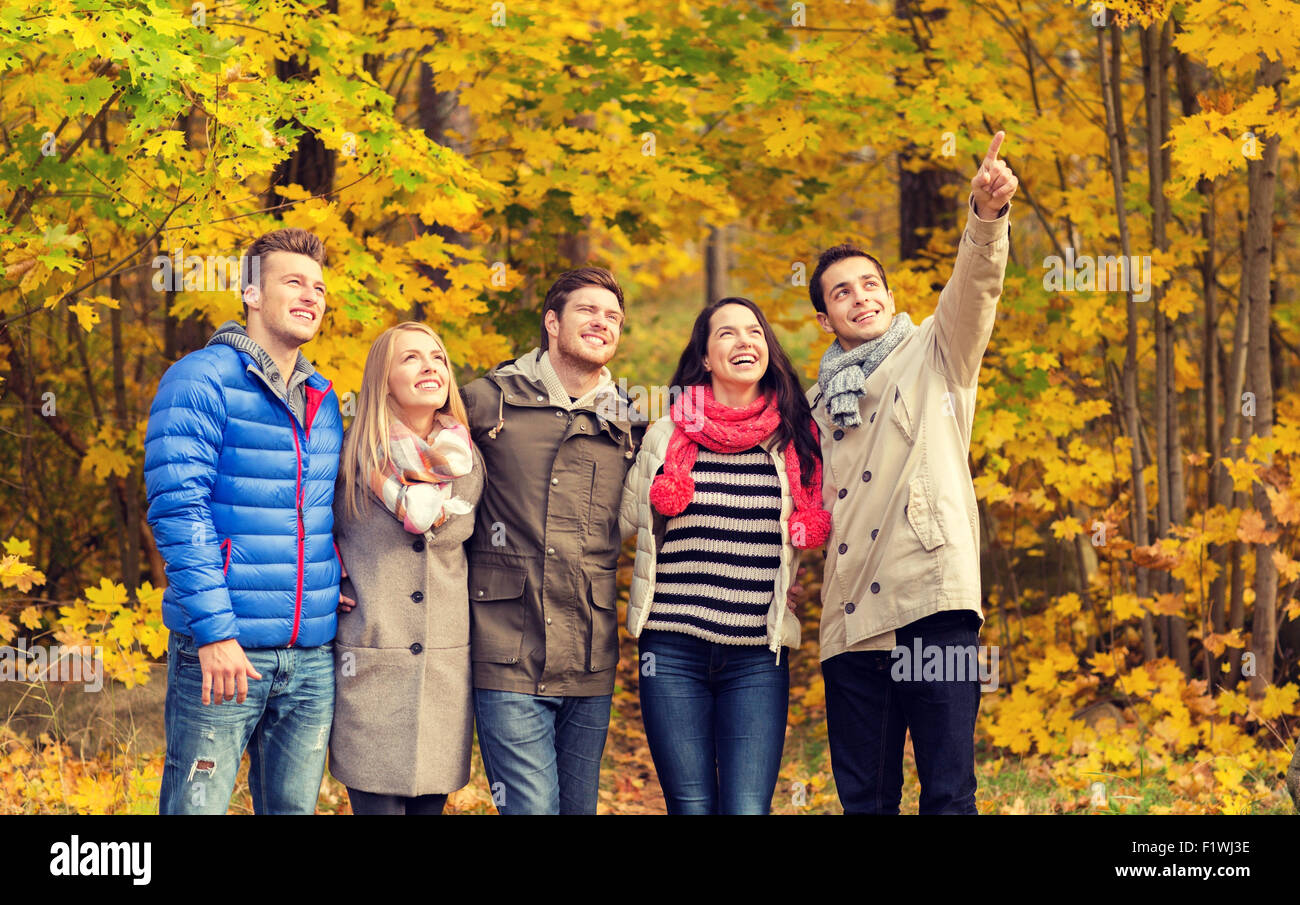 group of smiling men and women in autumn park Stock Photo - Alamy