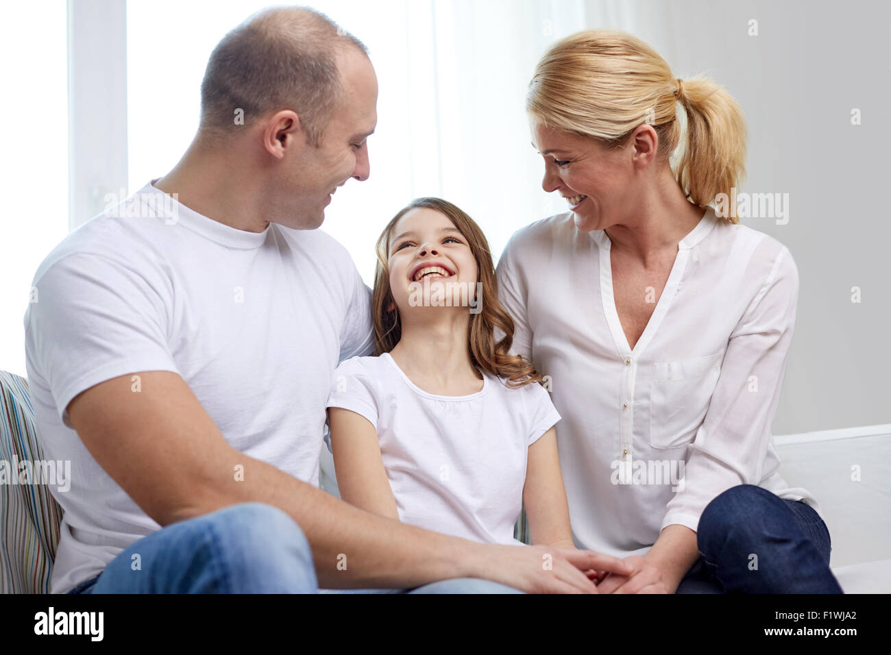 happy parents with little daughter at home Stock Photo