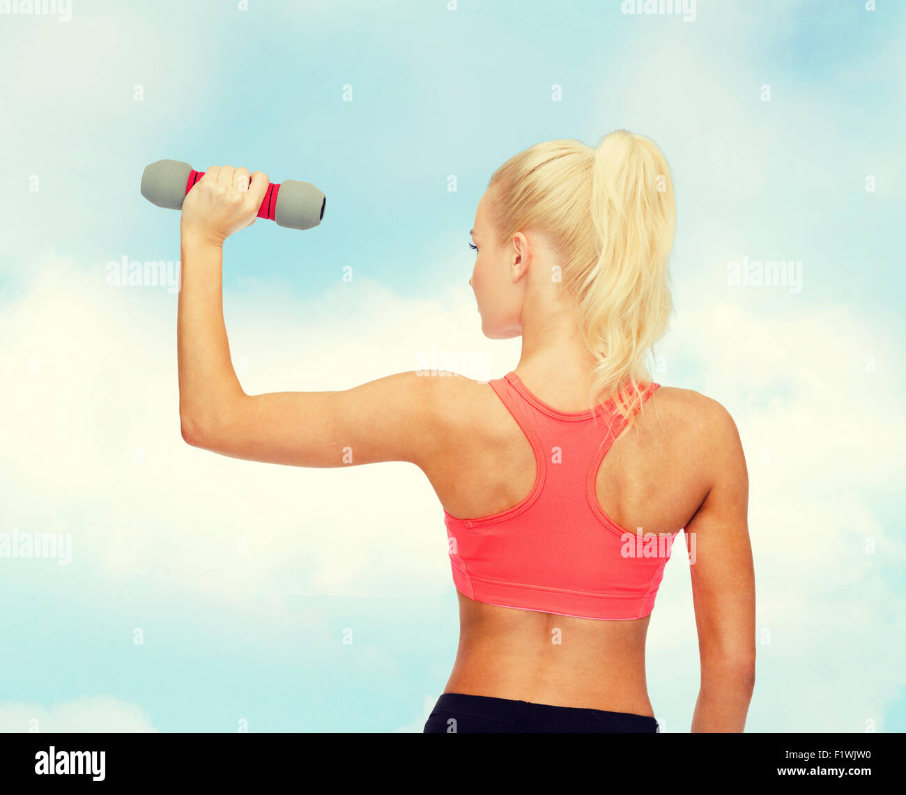 young sporty woman with light dumbbell Stock Photo