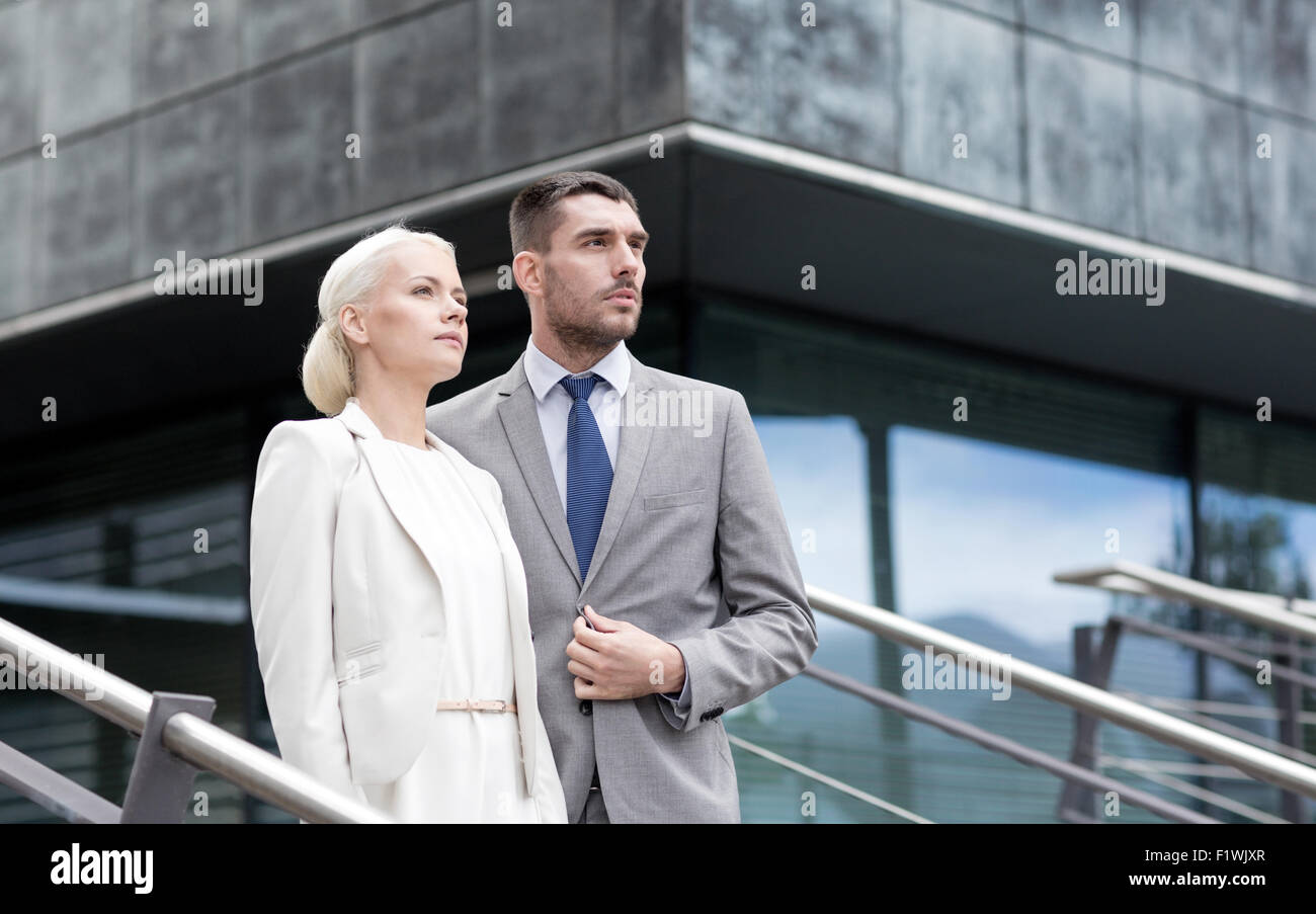 serious businessmen standing over office building Stock Photo - Alamy