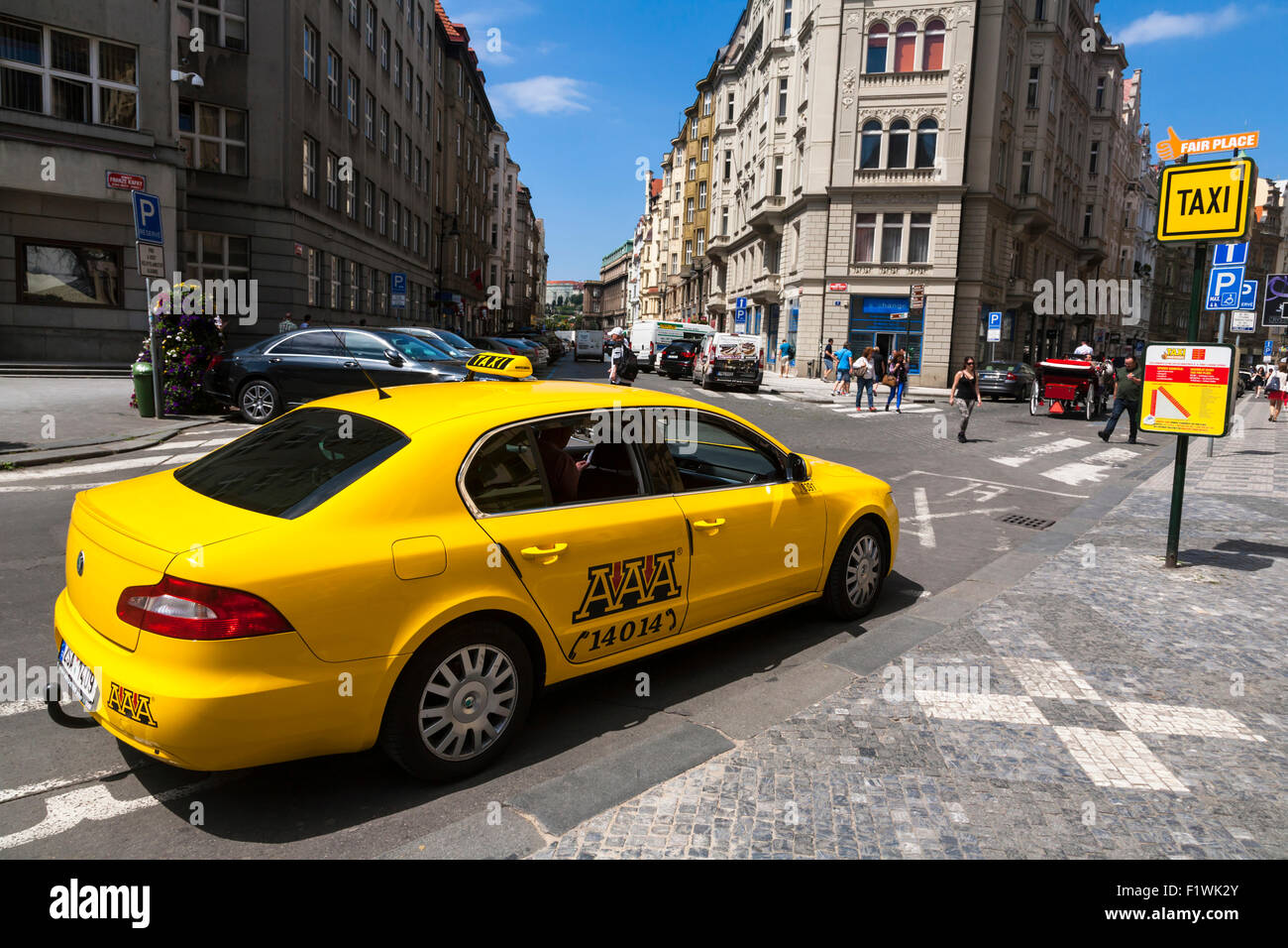 Yellow taxi sitting at the rank on a Prague street, Czech Republic. Stock Photo